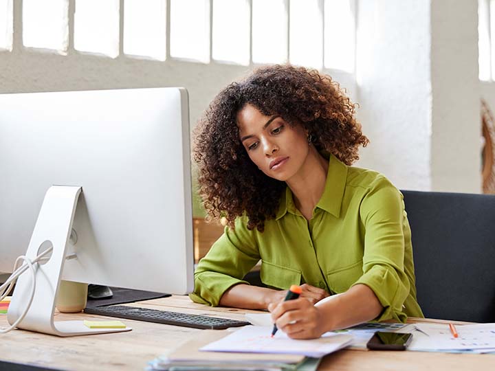 Woman with documents sitting at her desk