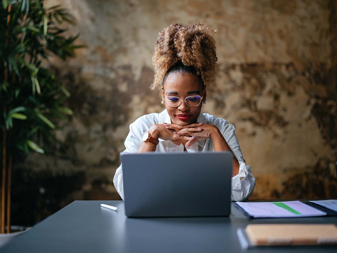 Woman smiling at laptop