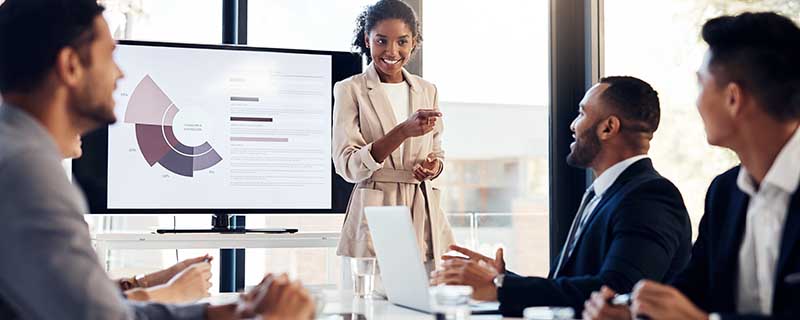 Shot of a young businesswoman delivering a presentation to her colleagues in the boardroom of a modern office