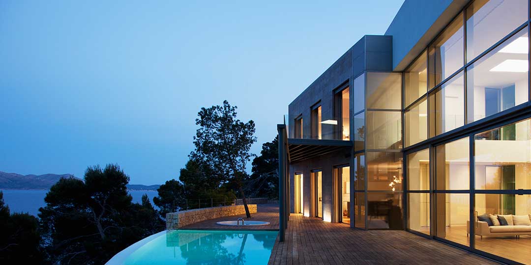 Pool outside modern house at twilight